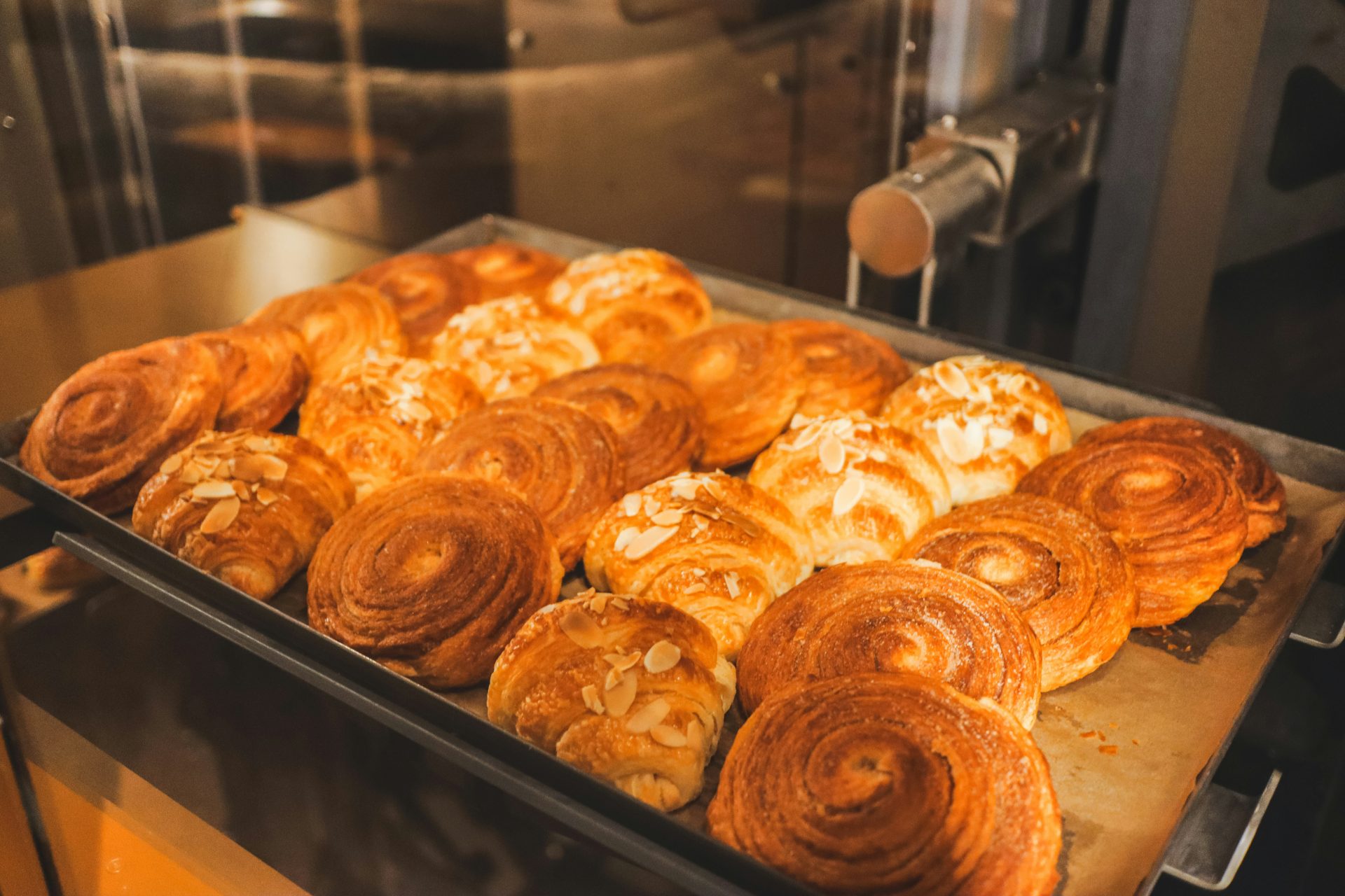 Freshly baked pastries sit on a tray.